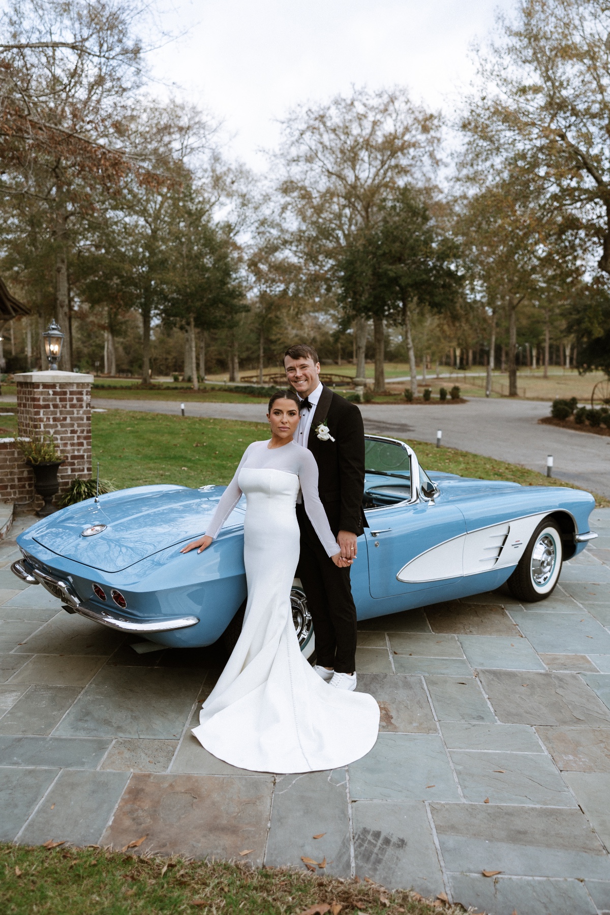 justin steele and libby pose with blue vintage car at wedding