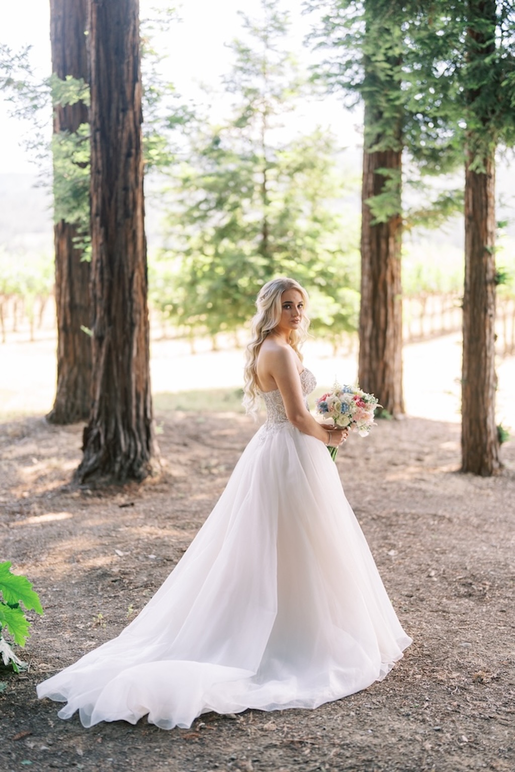 bride in custom wedding gown with beaded bodice and tulle skirt