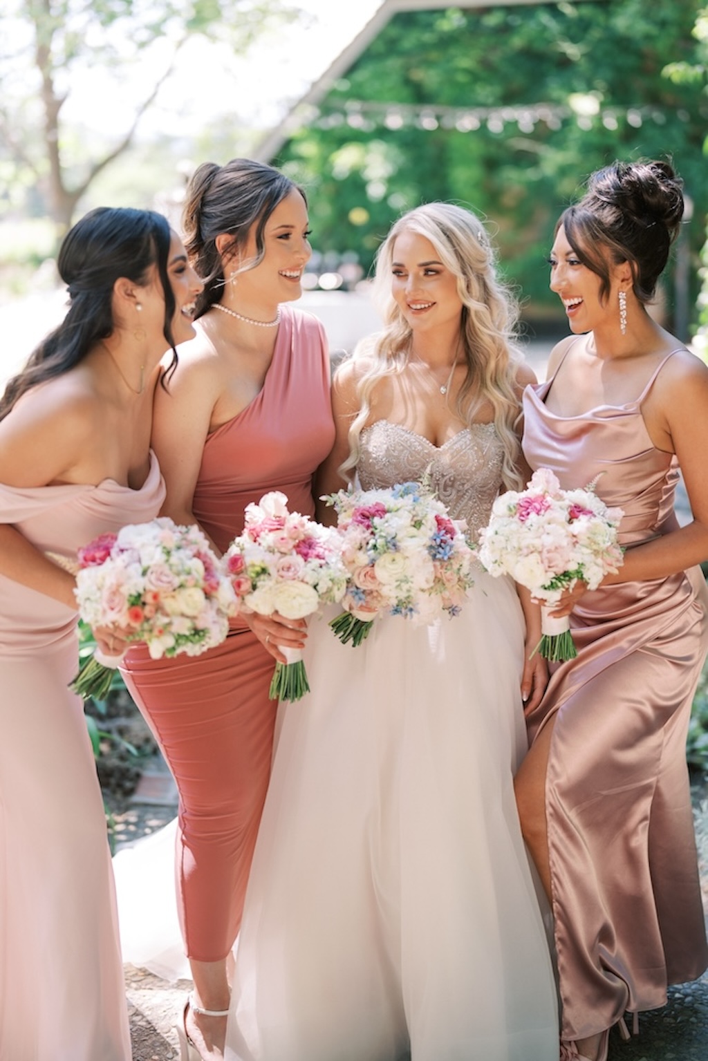 bride with bridesmaids in mix and match blush and rose dresses