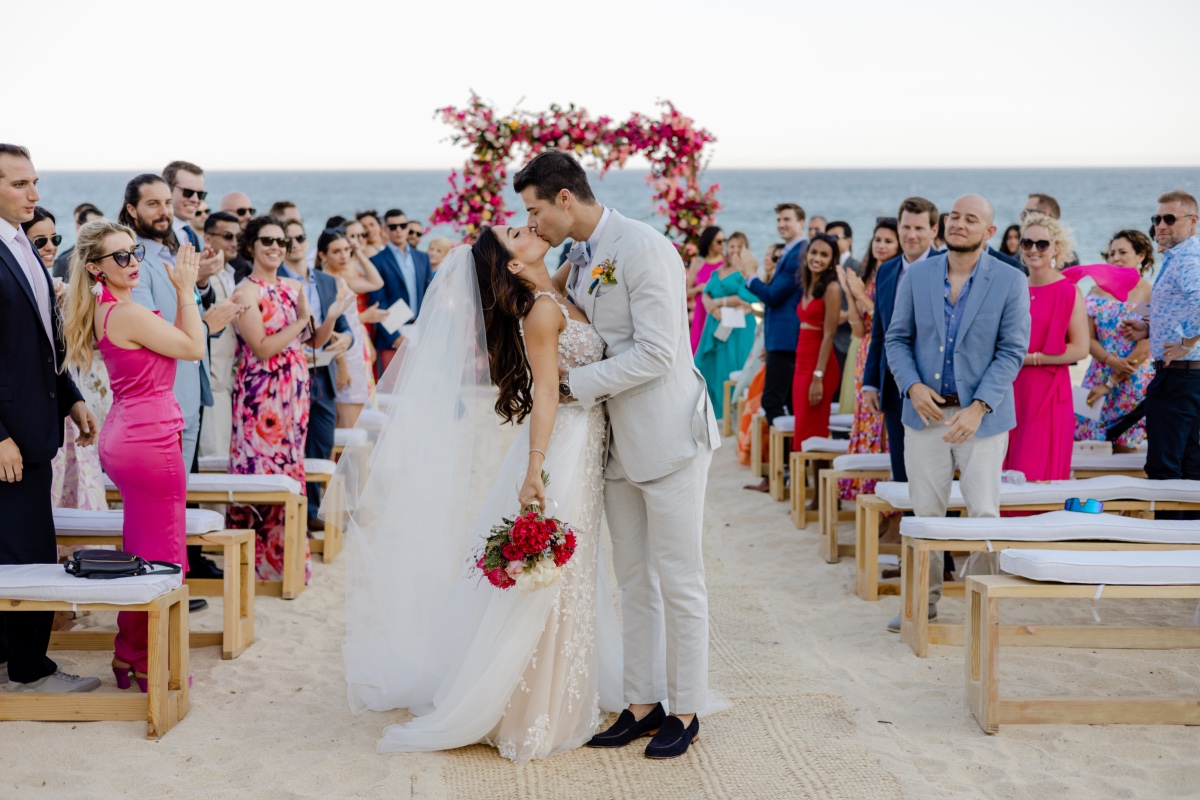 bright beach wedding ceremony with benches