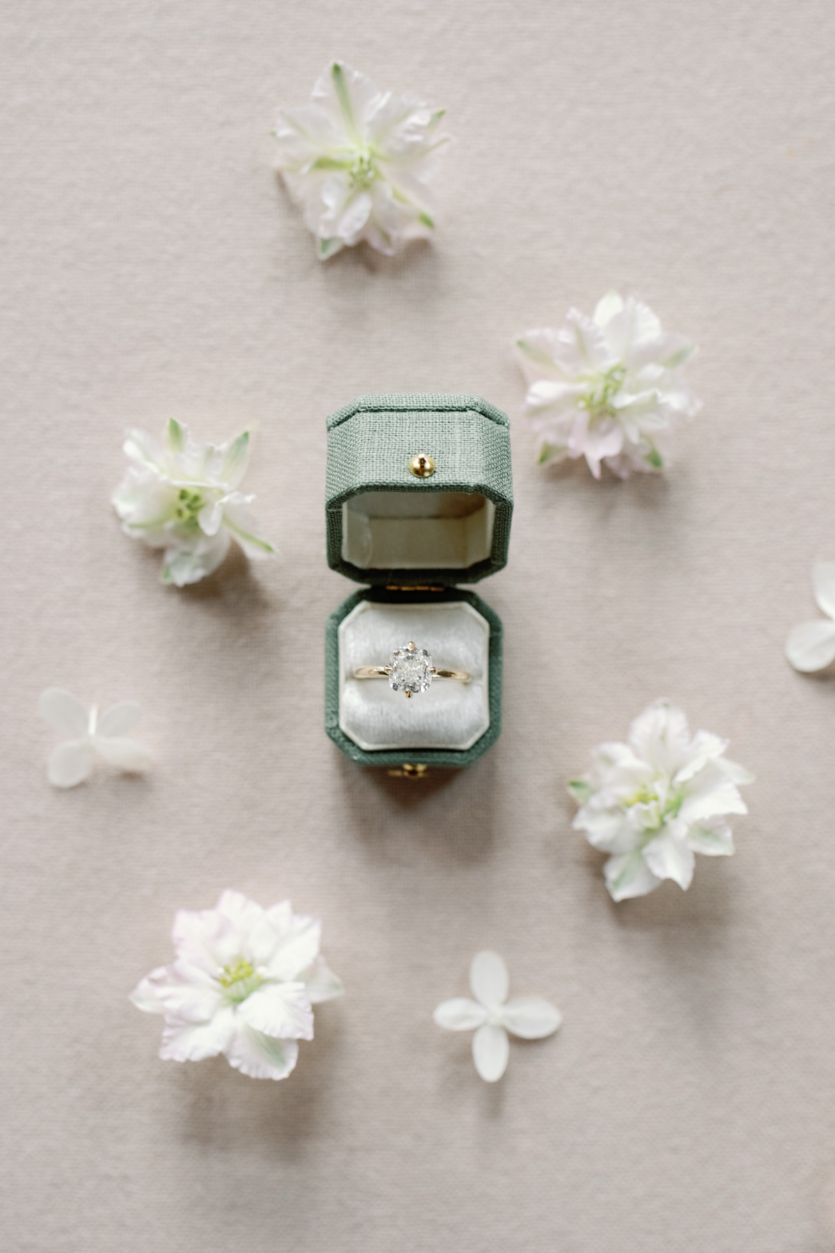 sage green ring box with radiant cut diamond ring