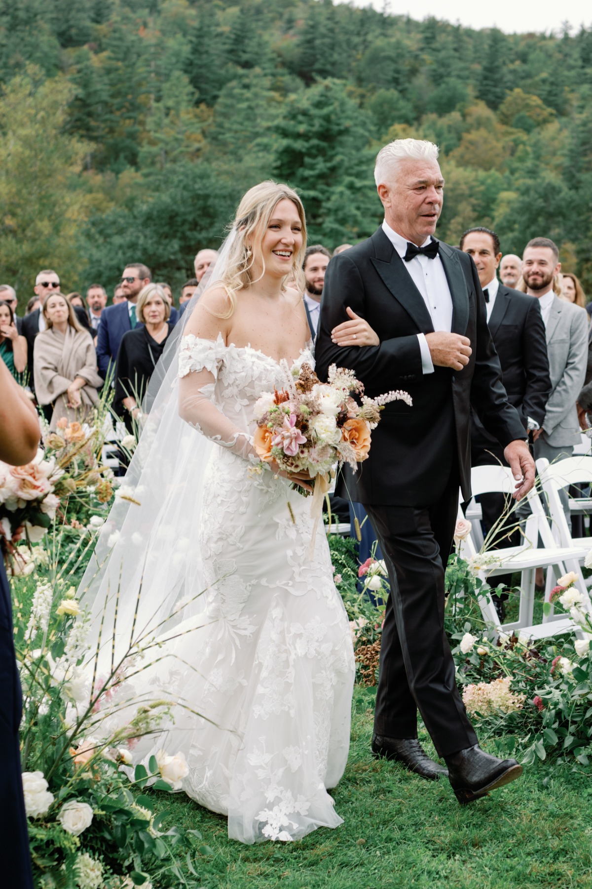 father of the bride walking bride down the aisle at outdoor wedding