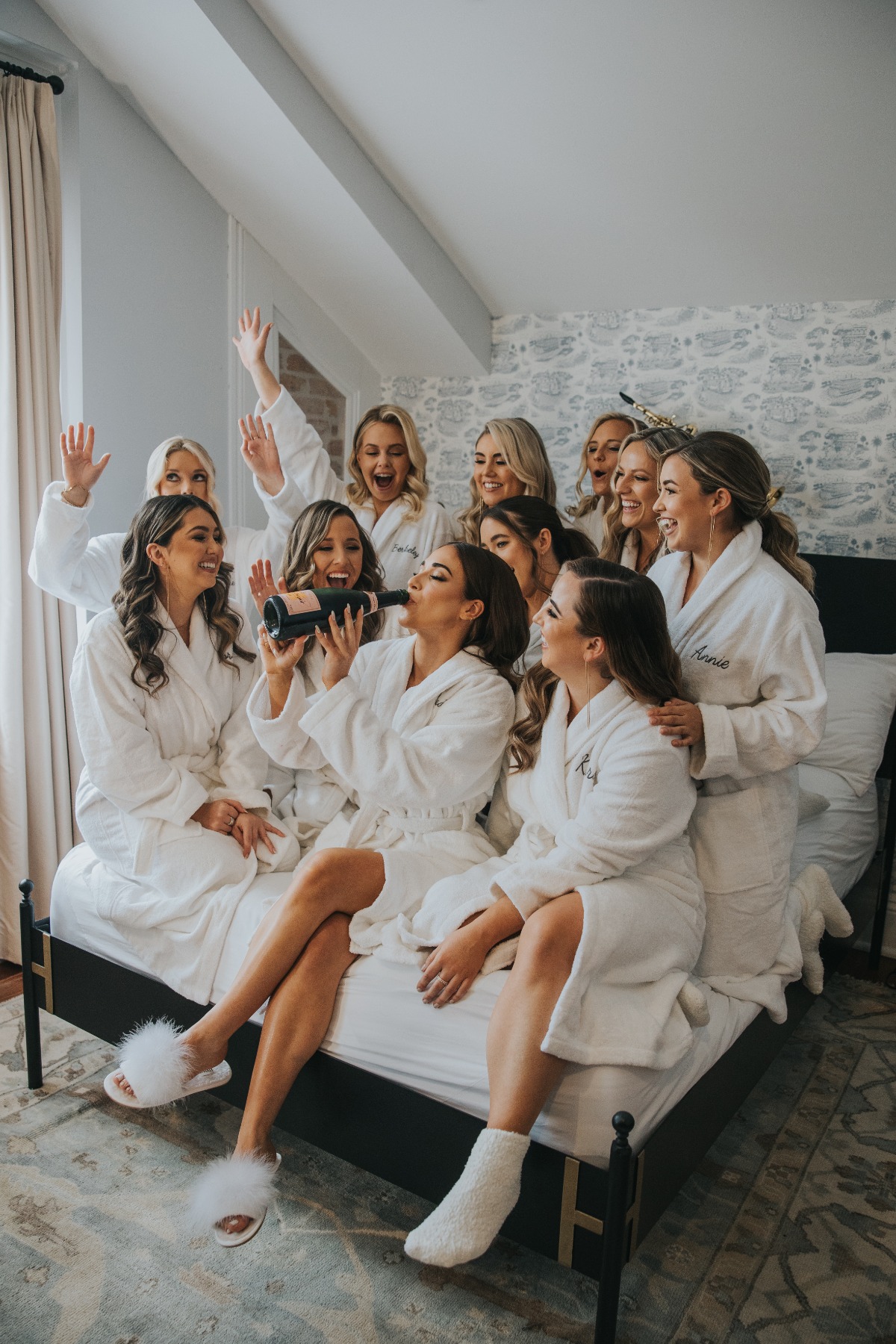 getting ready for wedding with bridesmaids in plush embroidered robes