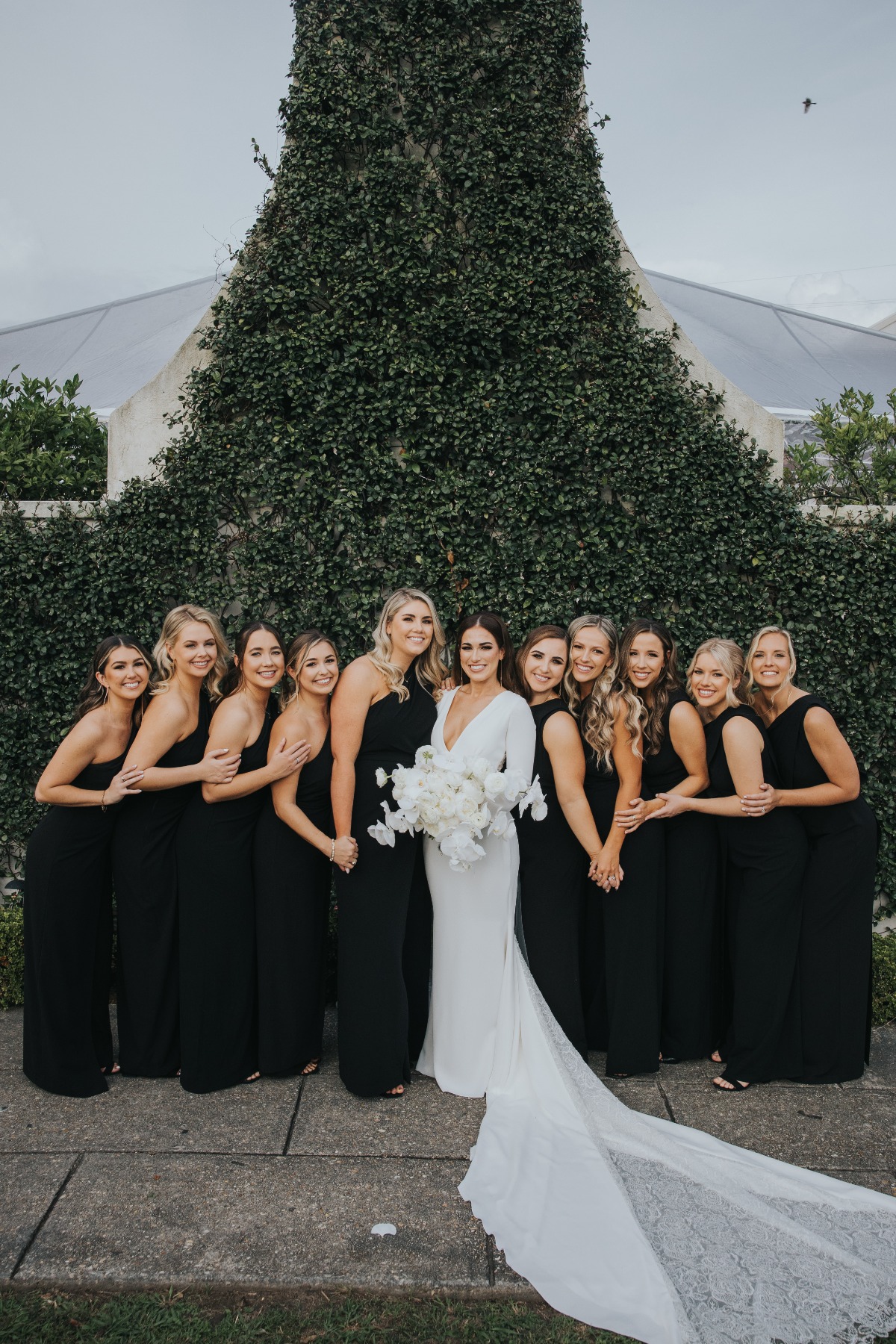 bridesmaids in one shouldered black dresses