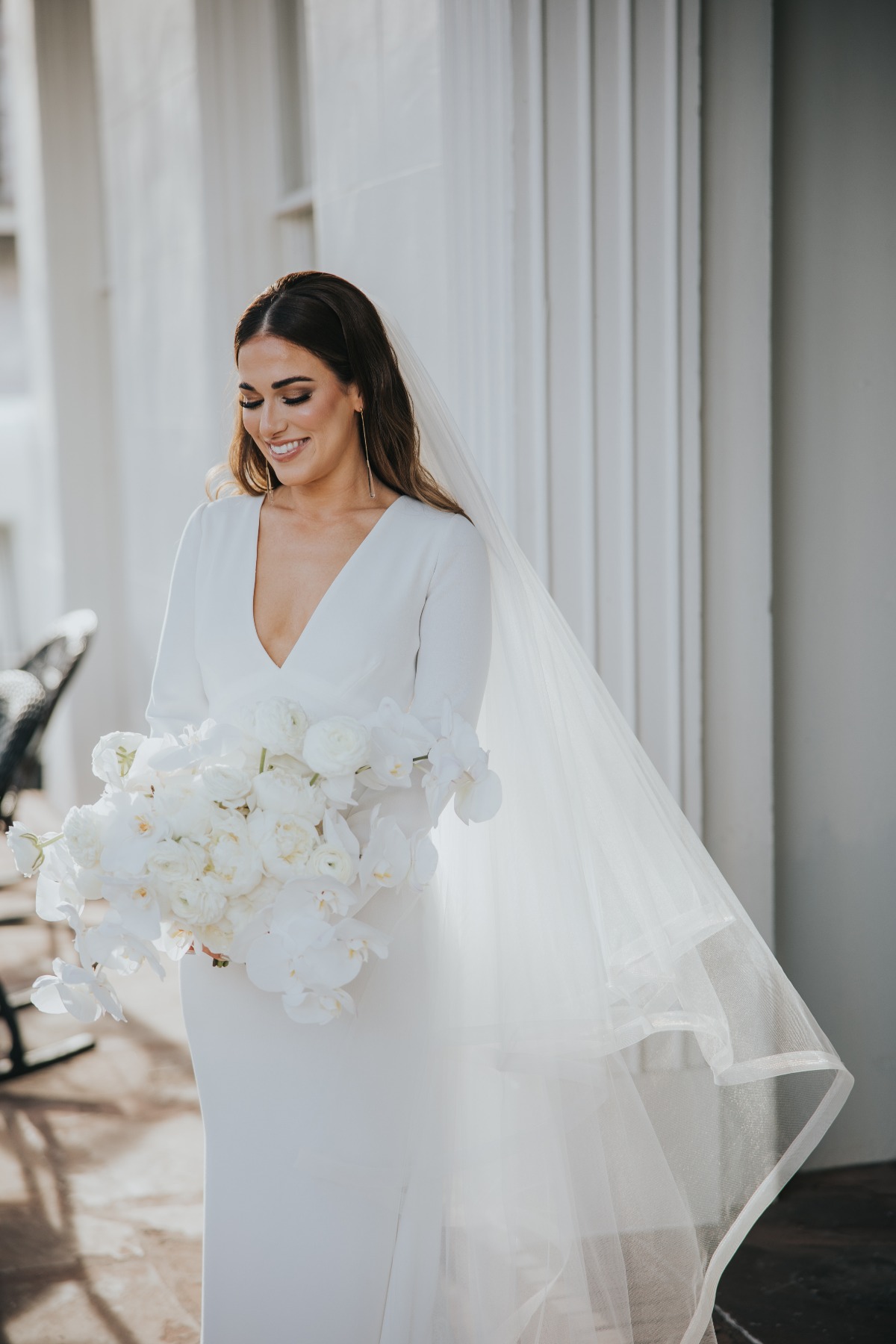 bride in custom minimalist long sleeve wedding gown