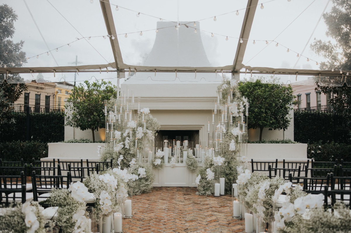 candlelight courtyard wedding ceremony with baby's breath and orchids