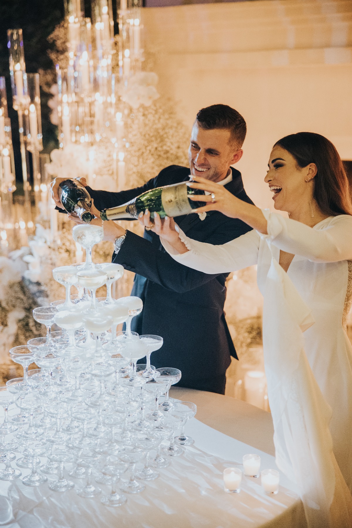 bride and groom pour a champagne tower