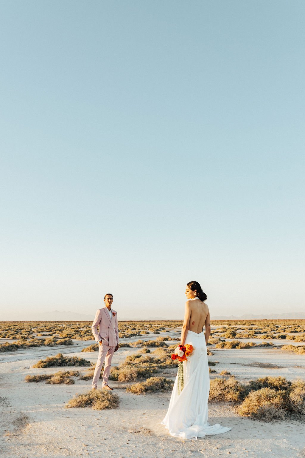 groom in pink suit for wedding