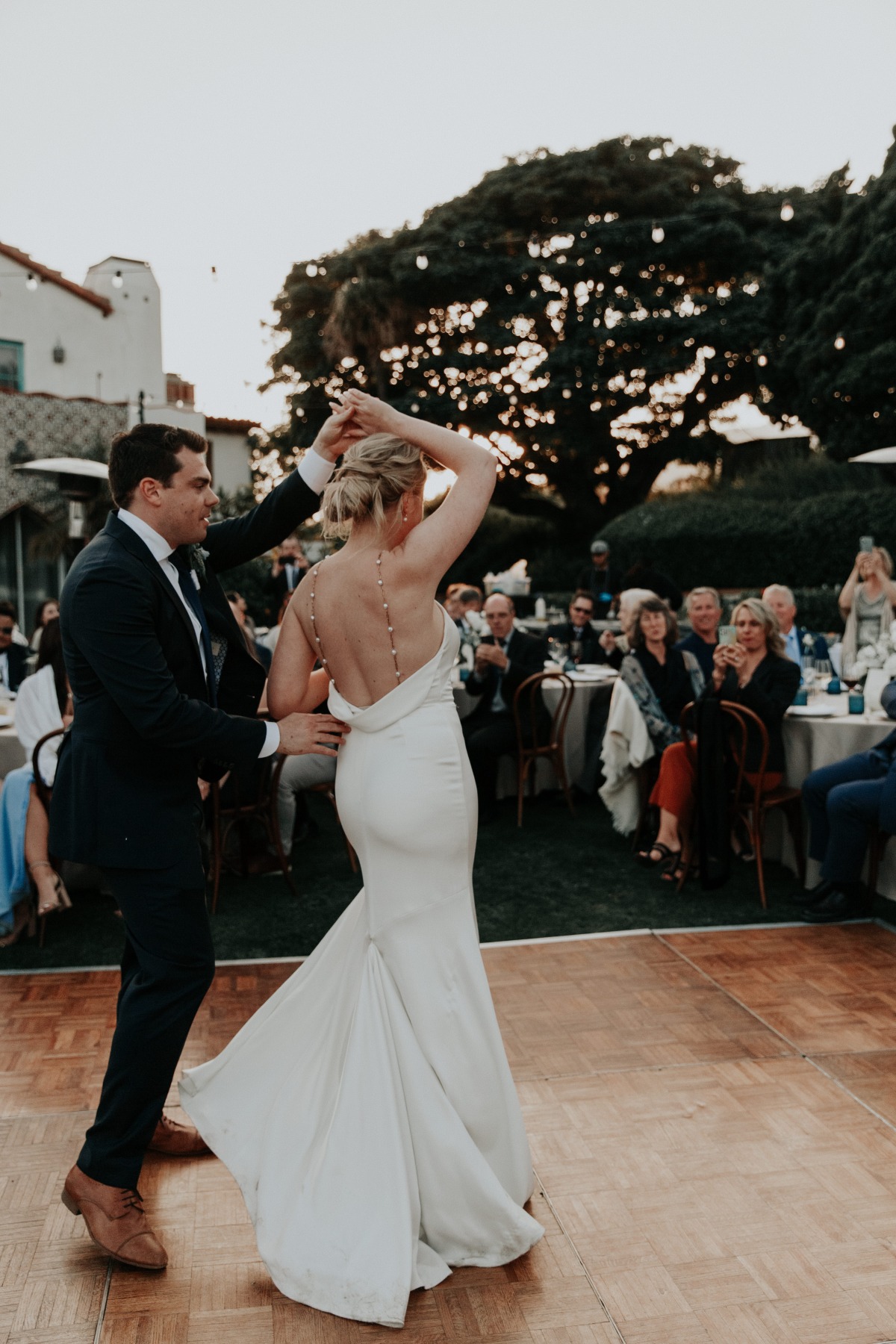 bride dancing in pearl gown