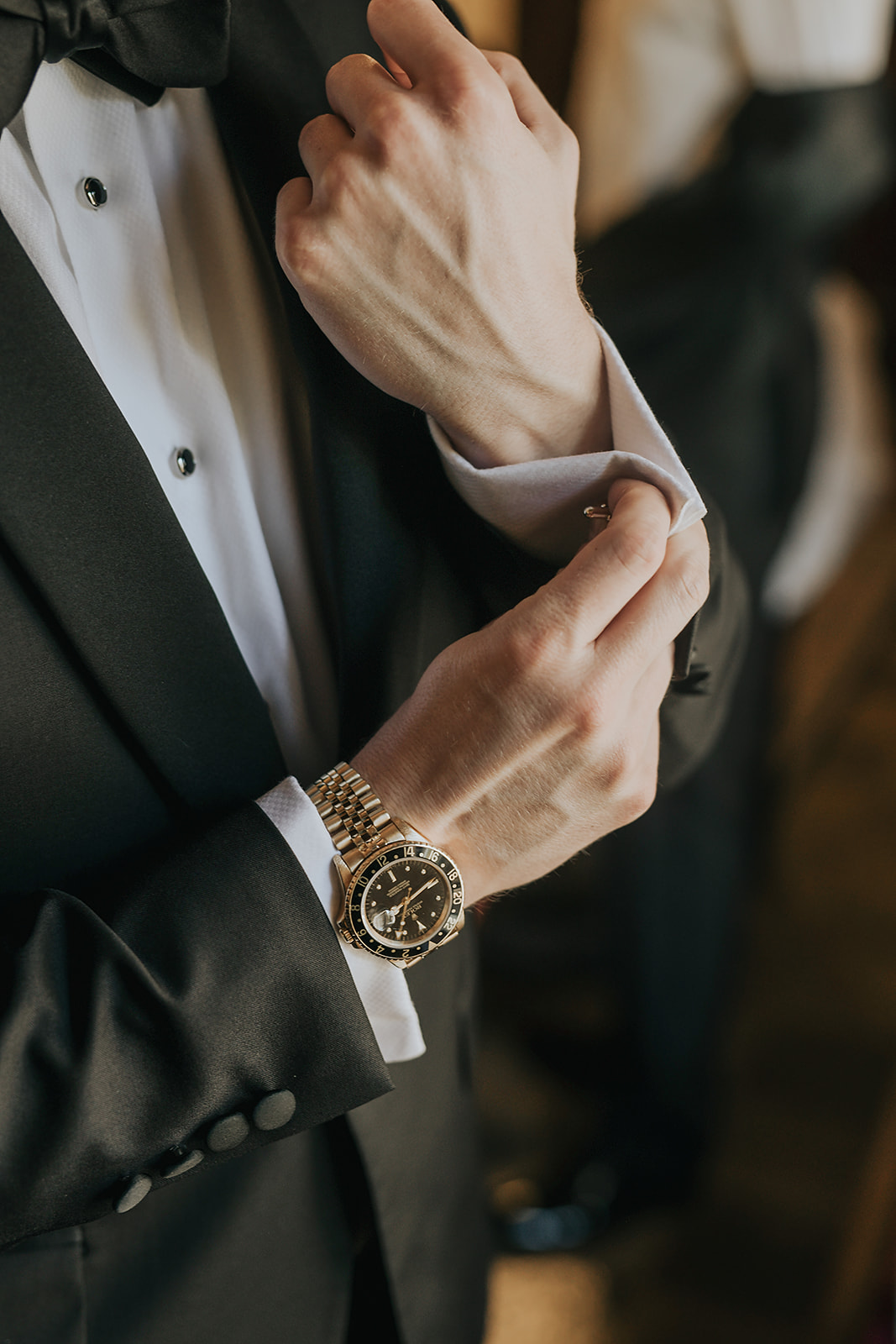 groom buttoning shirt for wedding