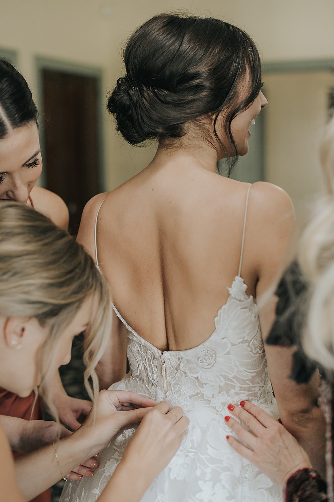 bridesmaids helping bride get ready