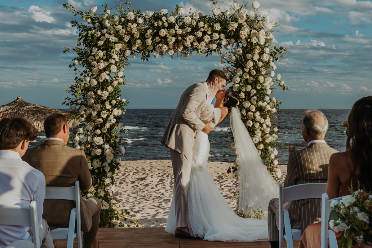 white rose and greenery floral arch