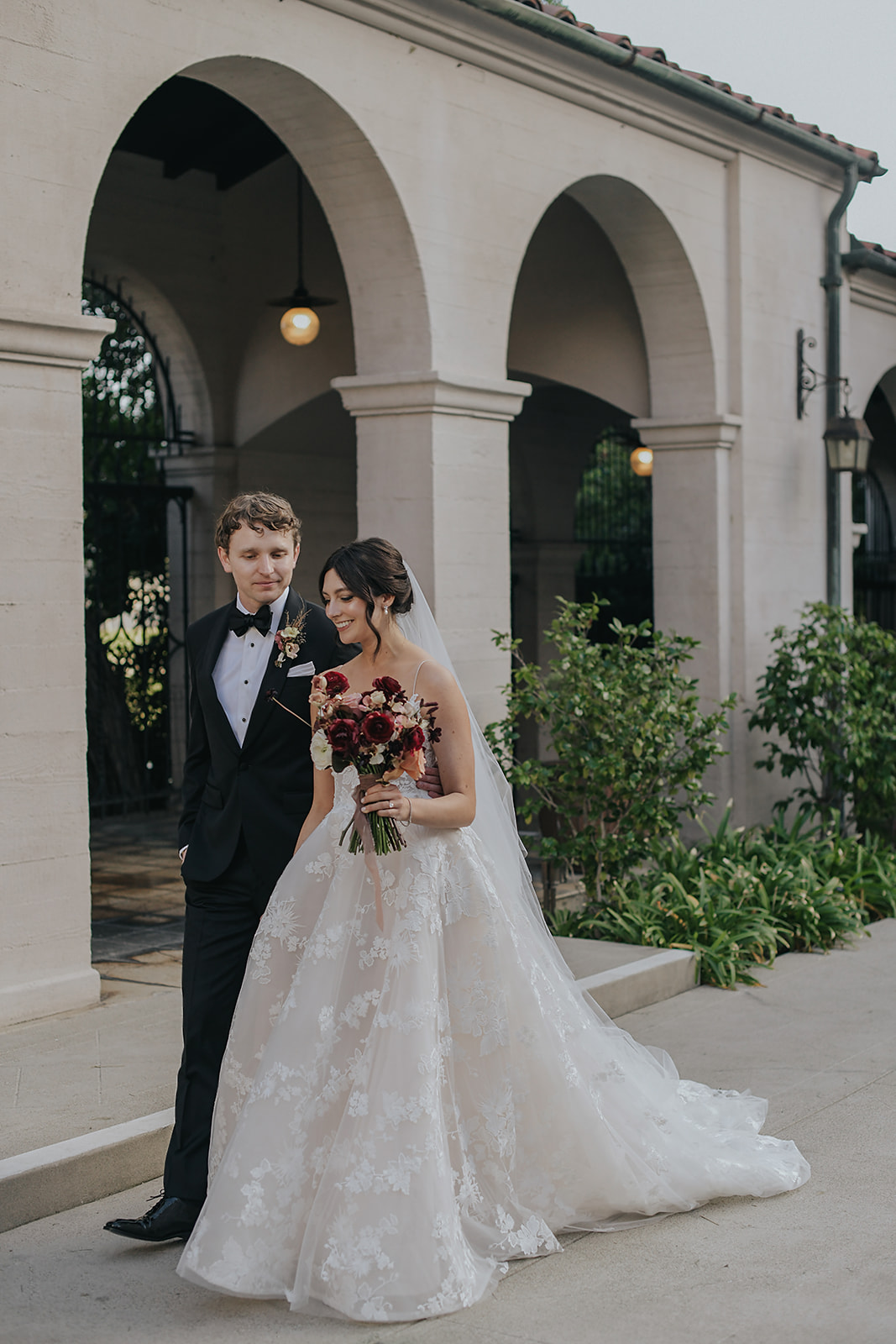 bride and groom walking together in garden