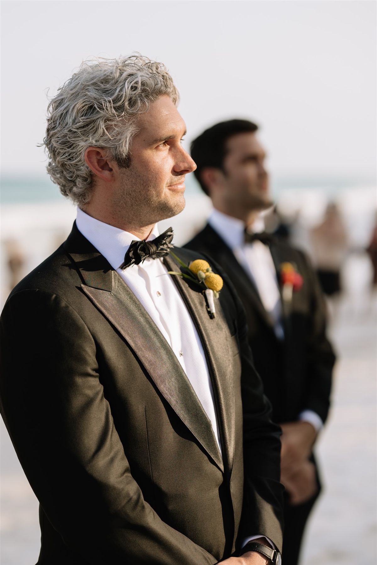 groom waiting for bride at beach wedding ceremony