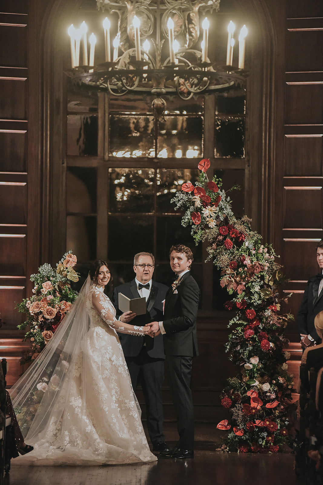 red and mauve indoor wedding ceremony