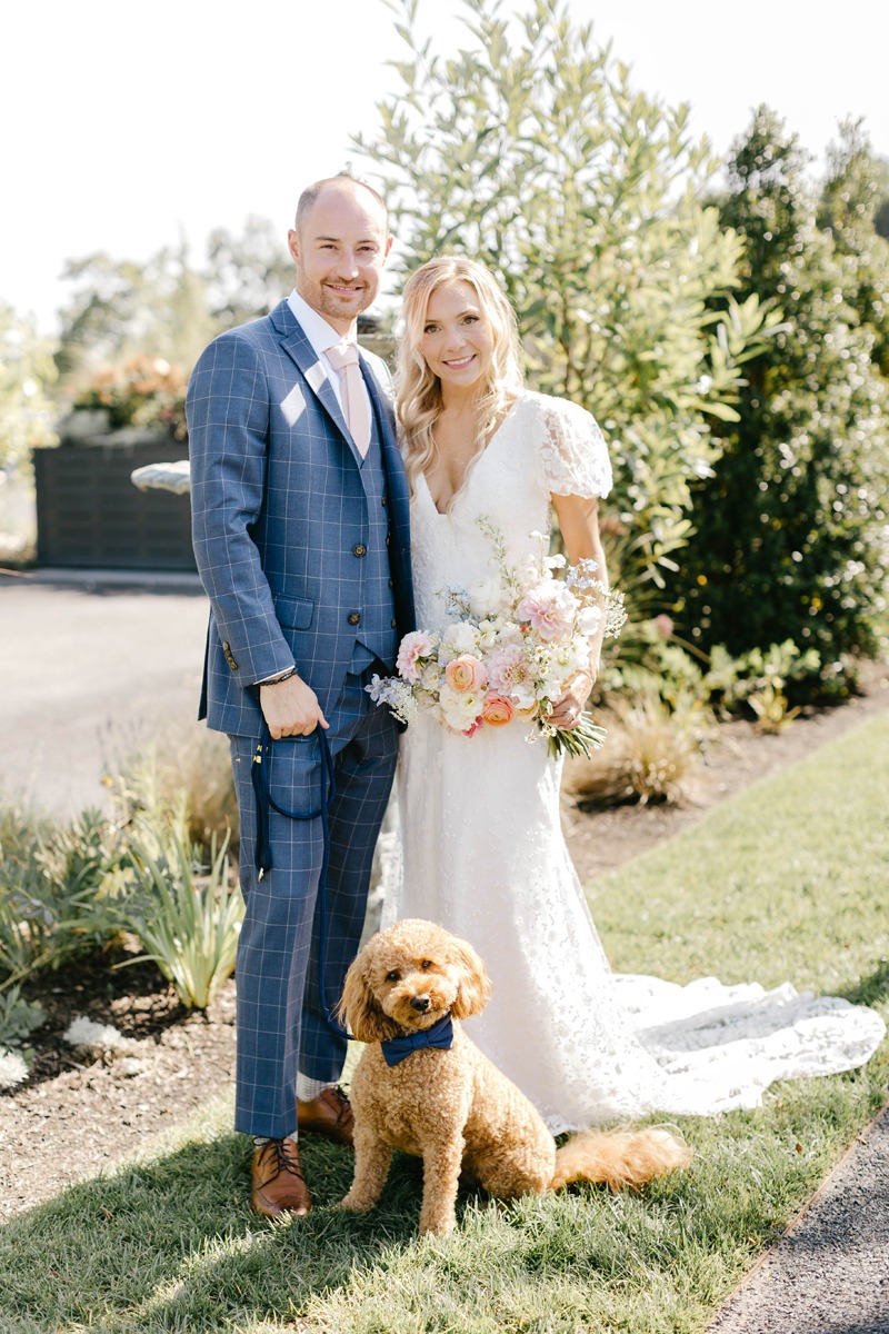 groom in blue window pane suit and dog at wedding