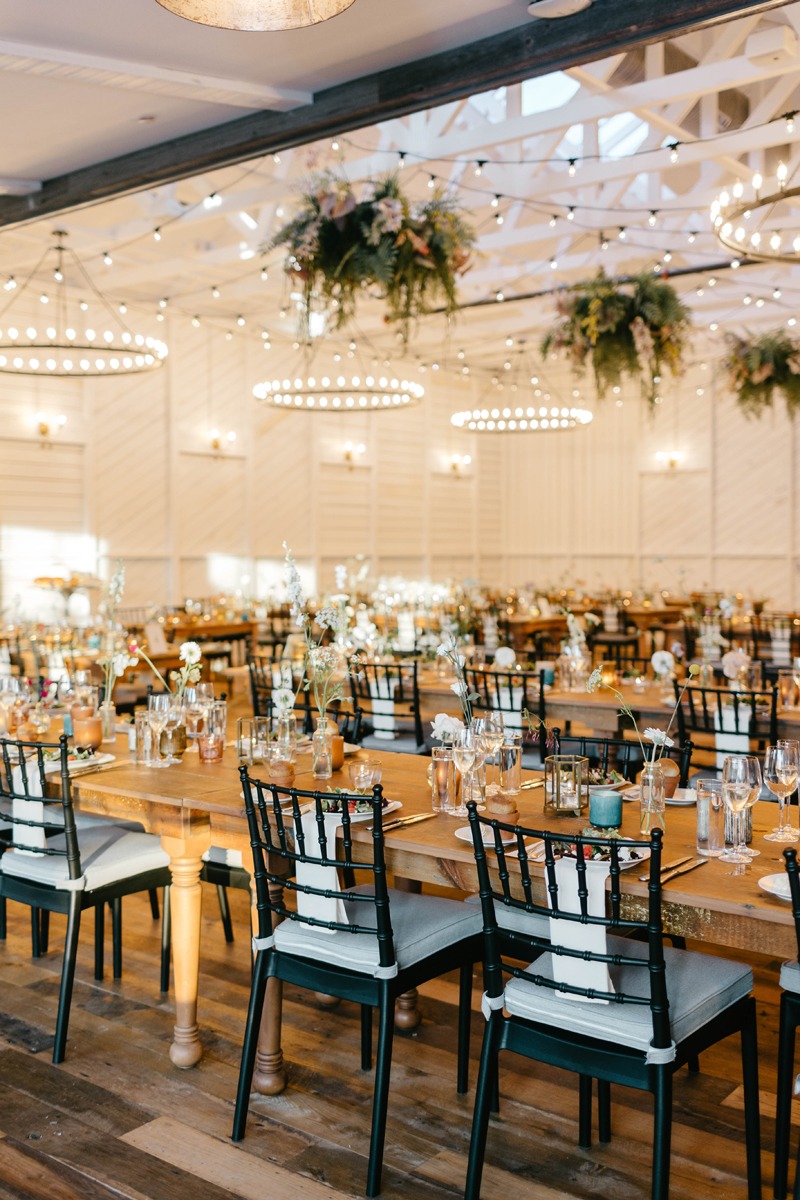 hanging floral installation at white barn wedding