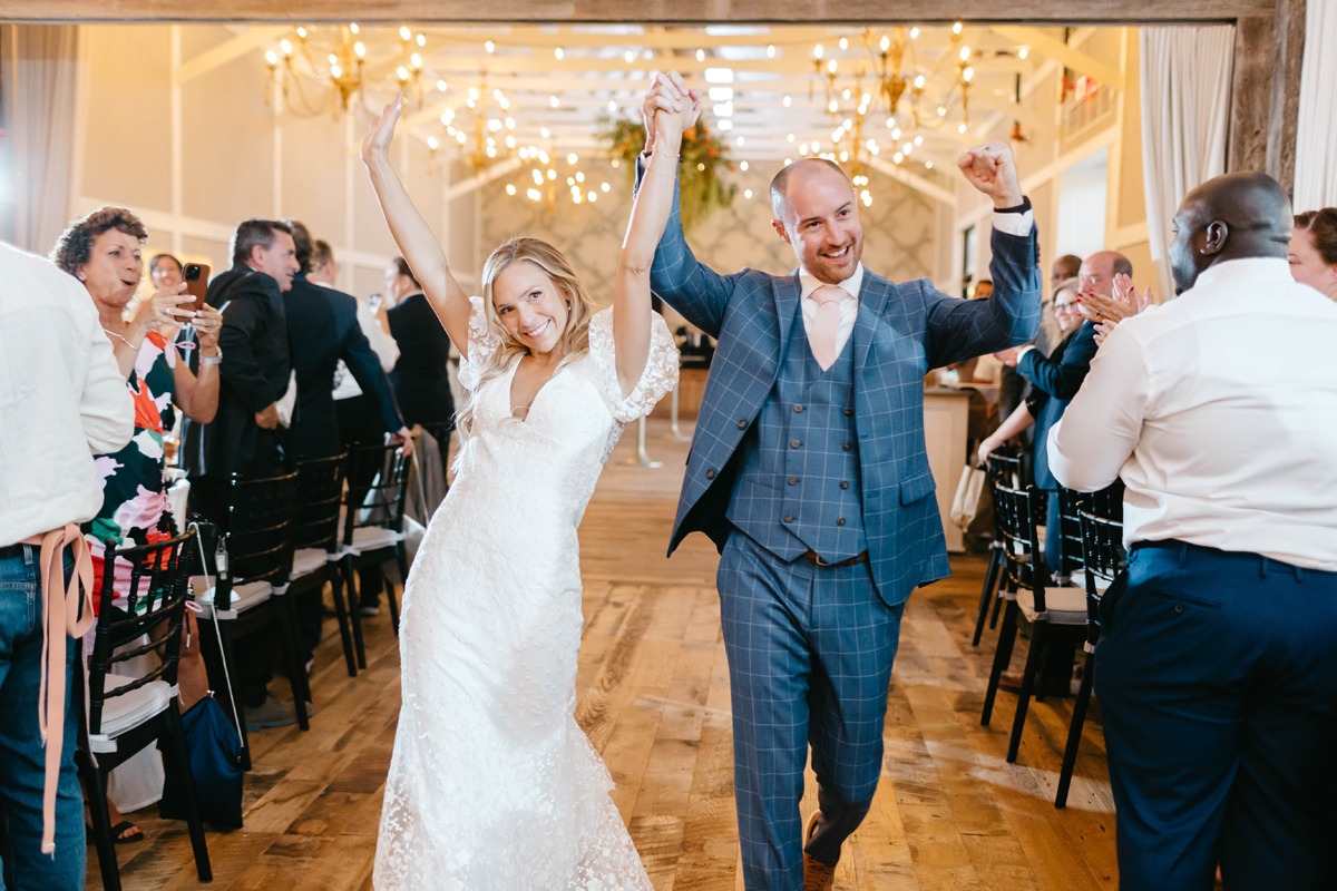 bride and groom at white barn wedding