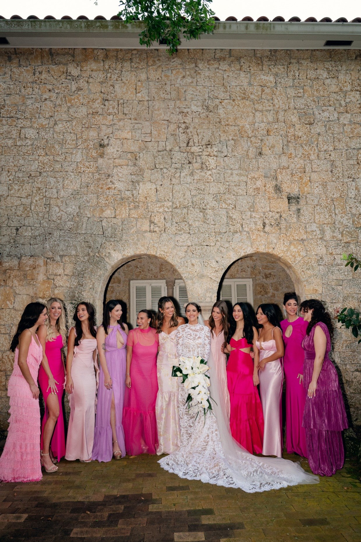 bride in white and bridesmaids in pink and purple