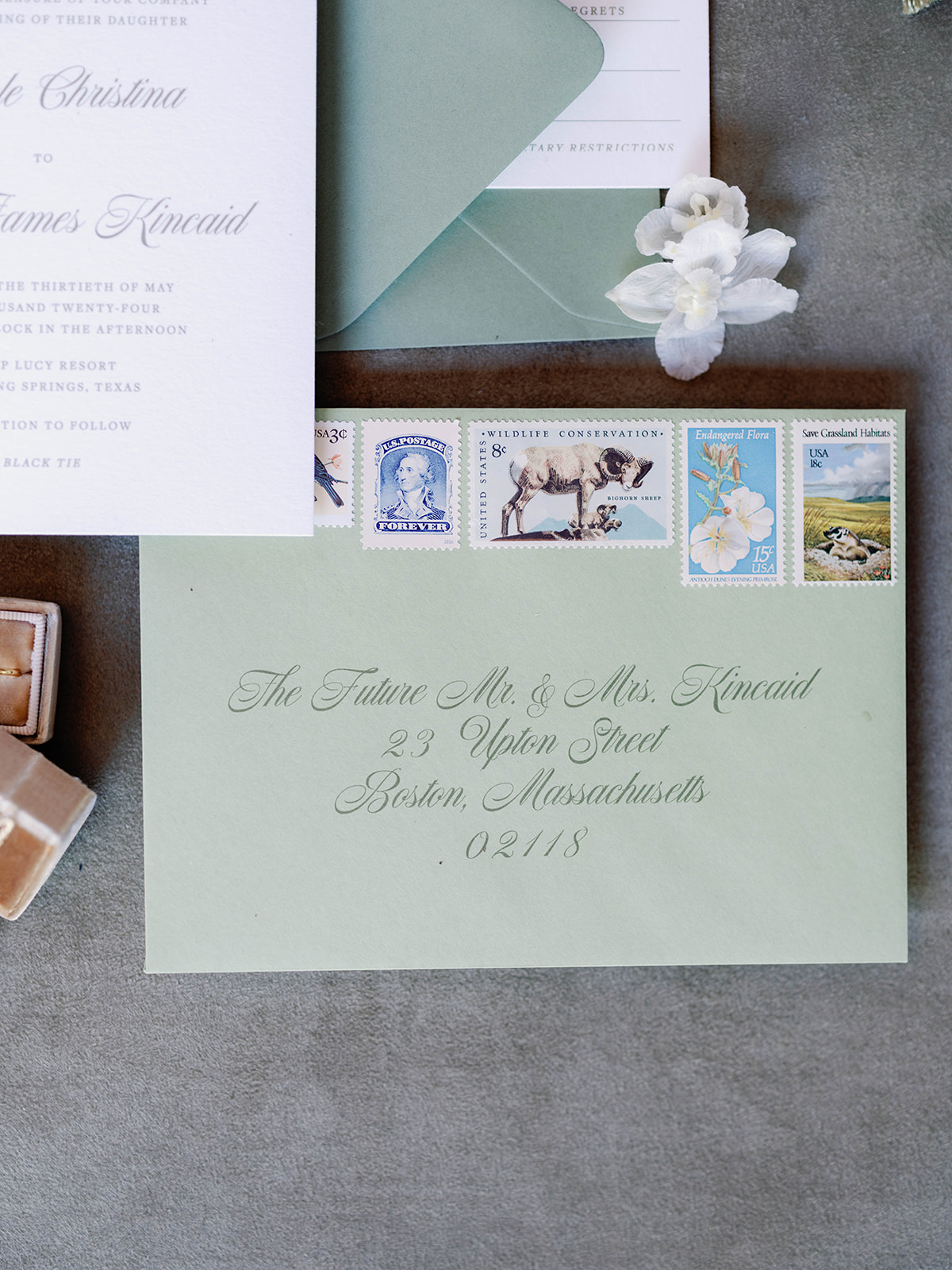 sage green wedding envelopes with vintage stamps