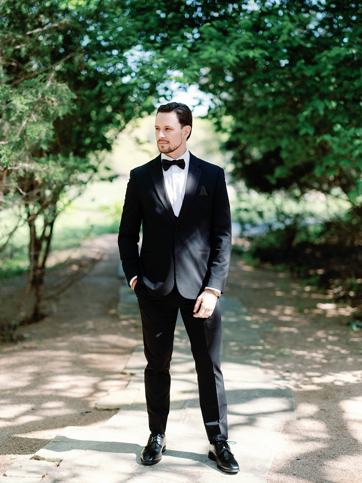 groom in black tux for garden wedding