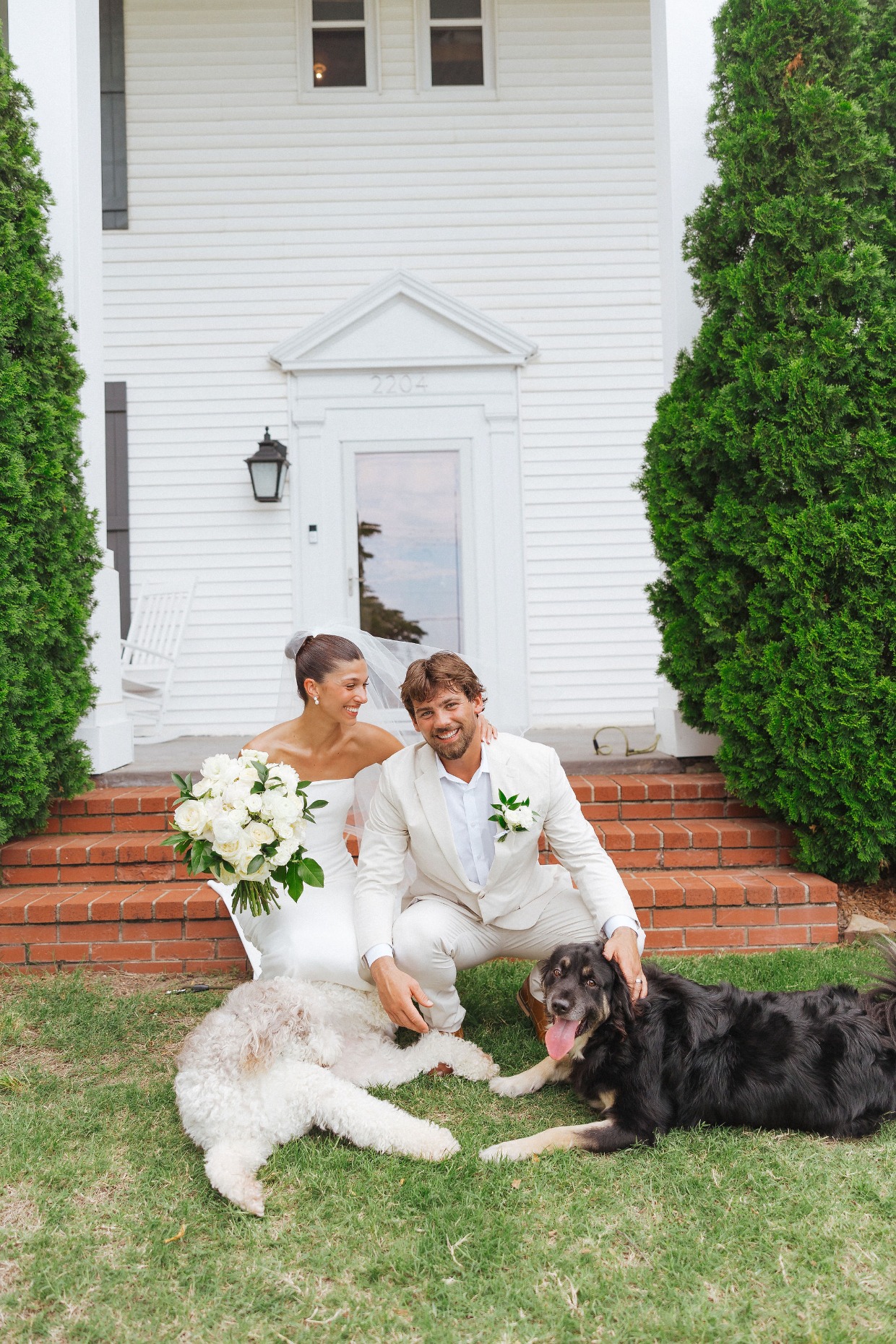 bride and groom with dogs at wedding planned by with great love