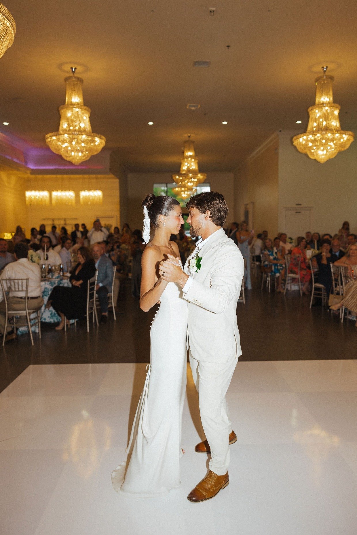 bride and groom dancing in ballroom with great love