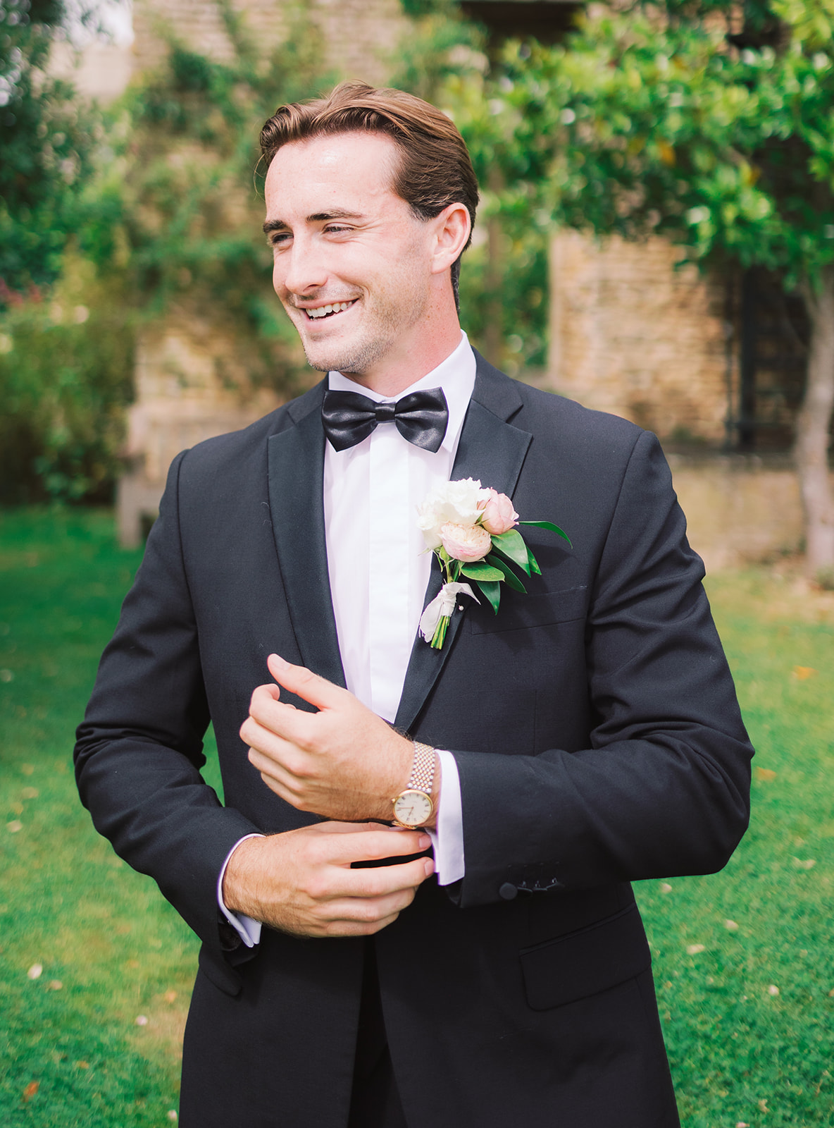 groom in tux at garden wedding