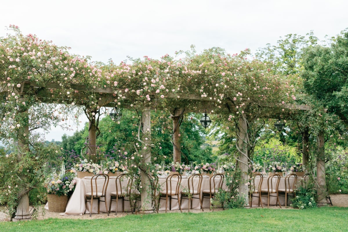 banquet table reception under outdoor arbor