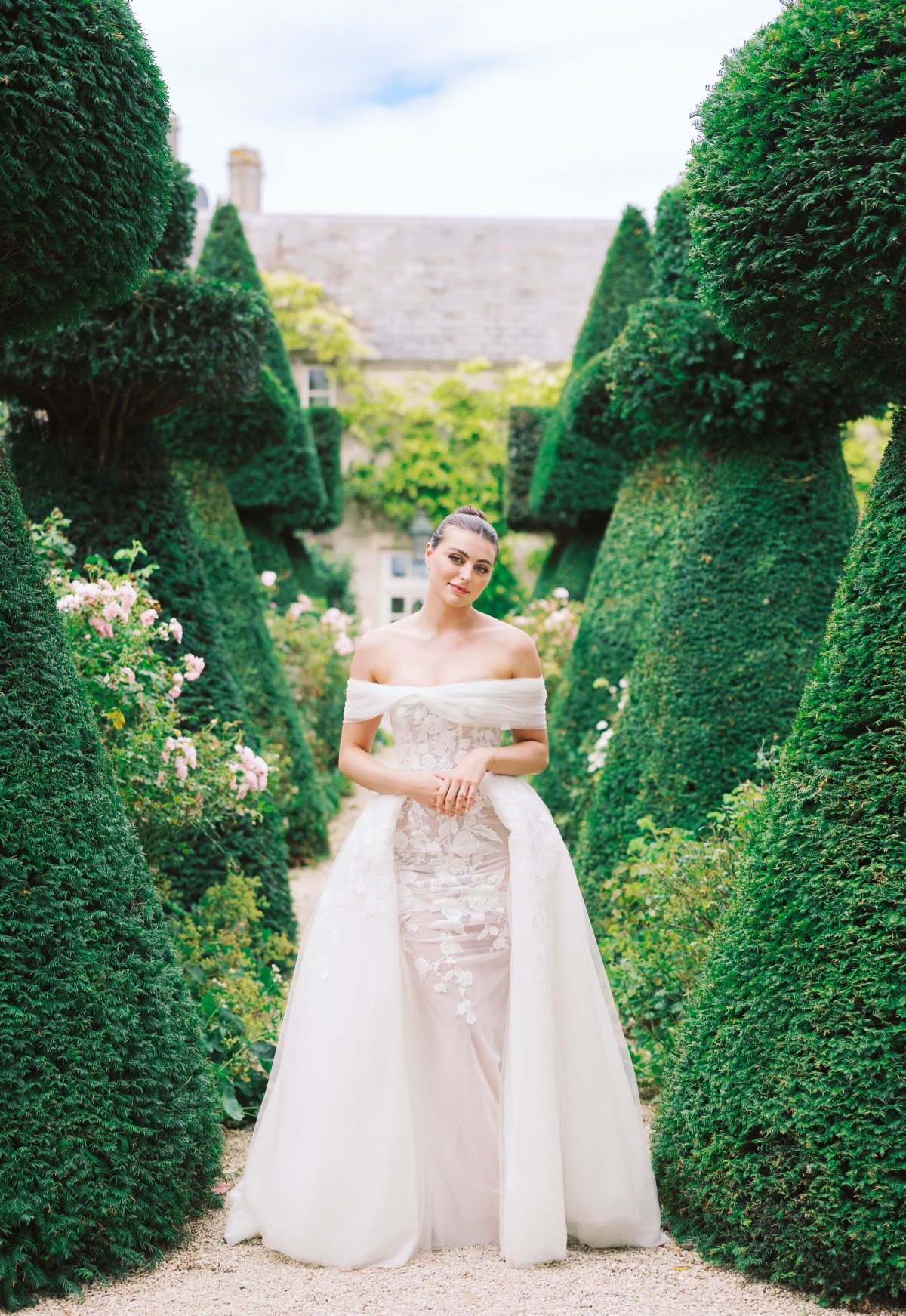 bride in tulle and lace ballgown for garden wedding with topiaries