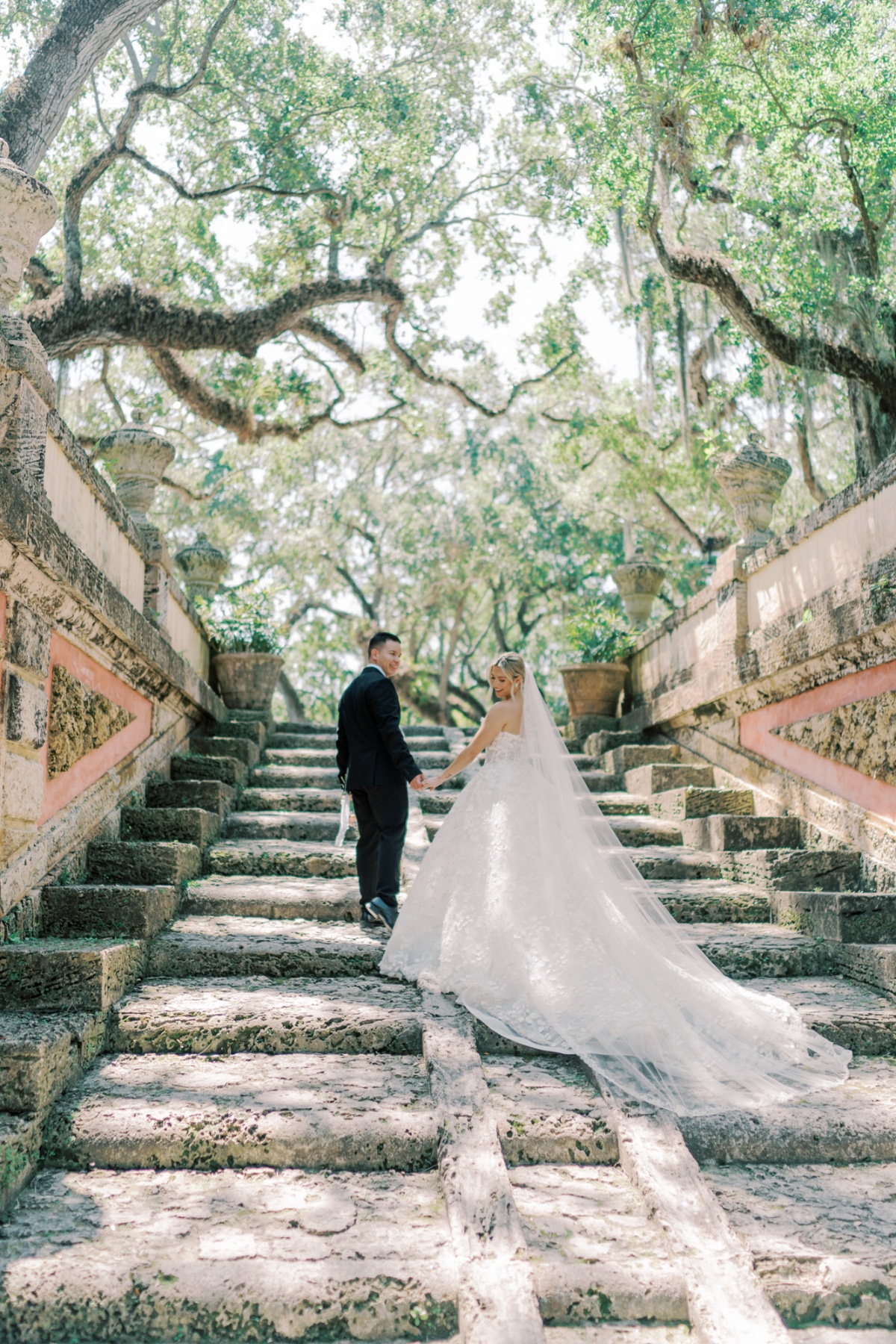 bride and groom in garden at vizcaya in miami