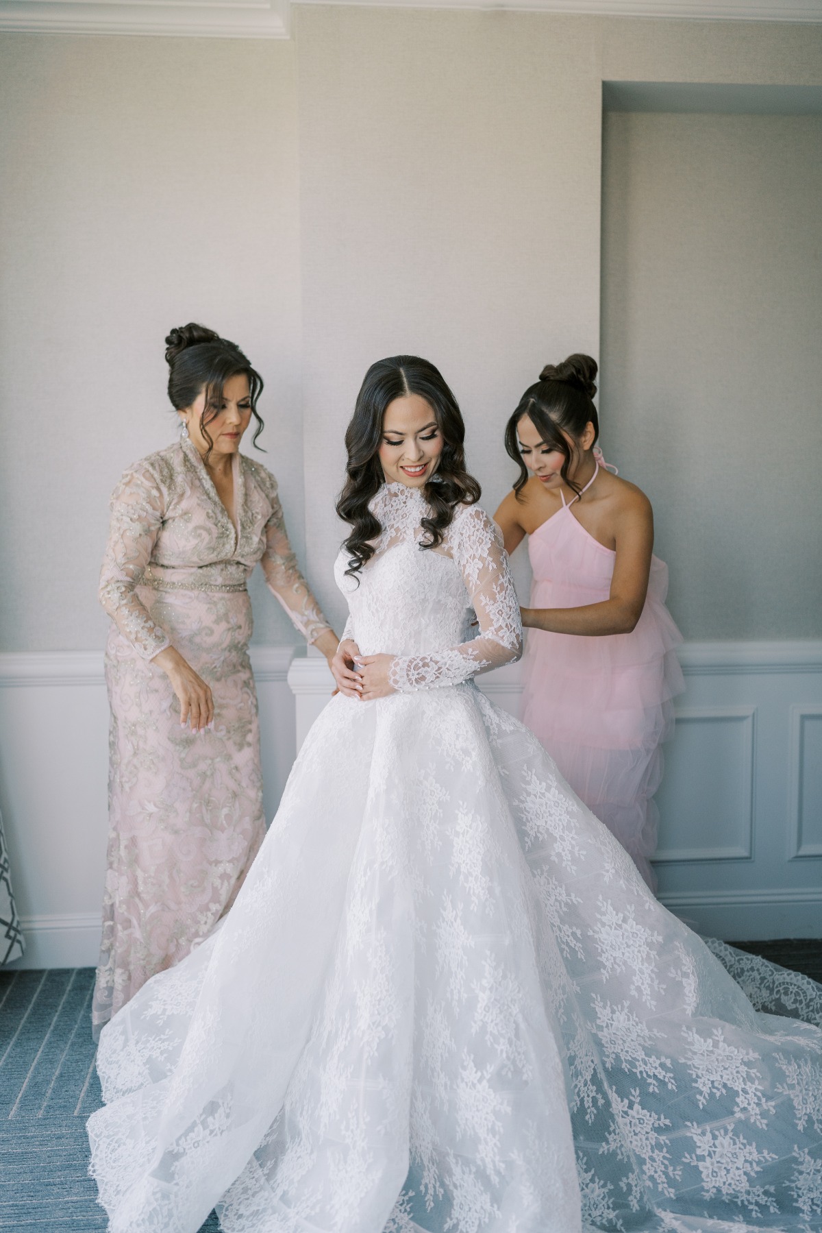 bride getting ready with mom and bridesmaid