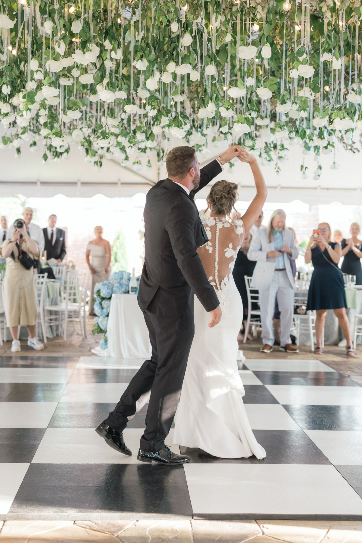 bride and groom dancing on checkerboard dance floor