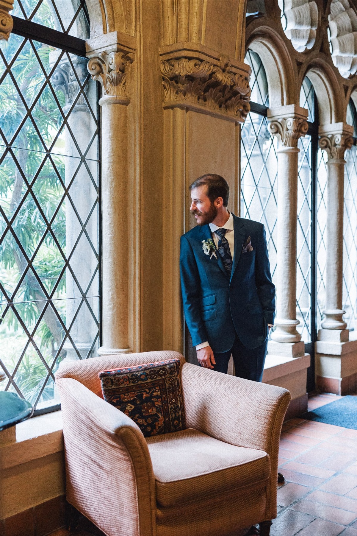 groom in blue suit with beard and mustache