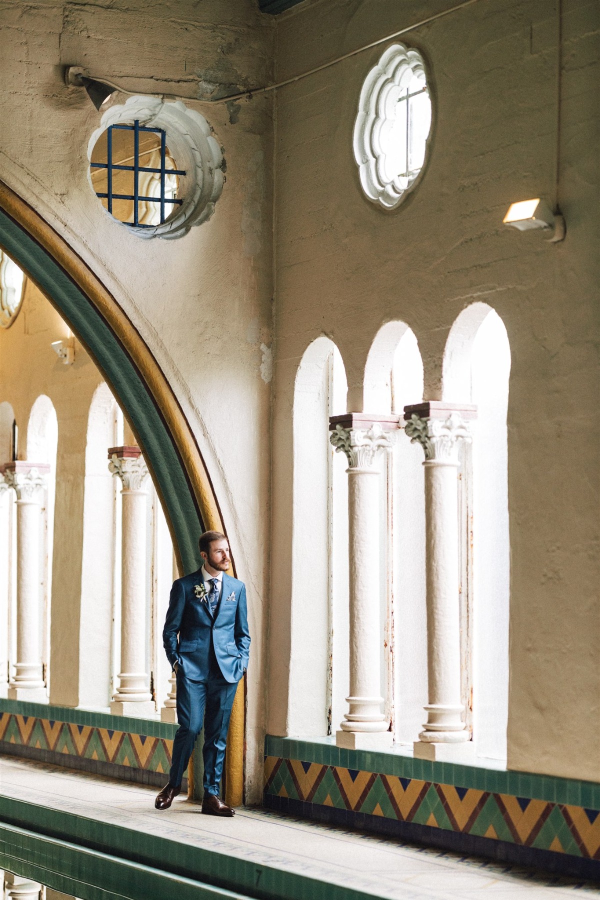 groom at indoor pool wedding venue