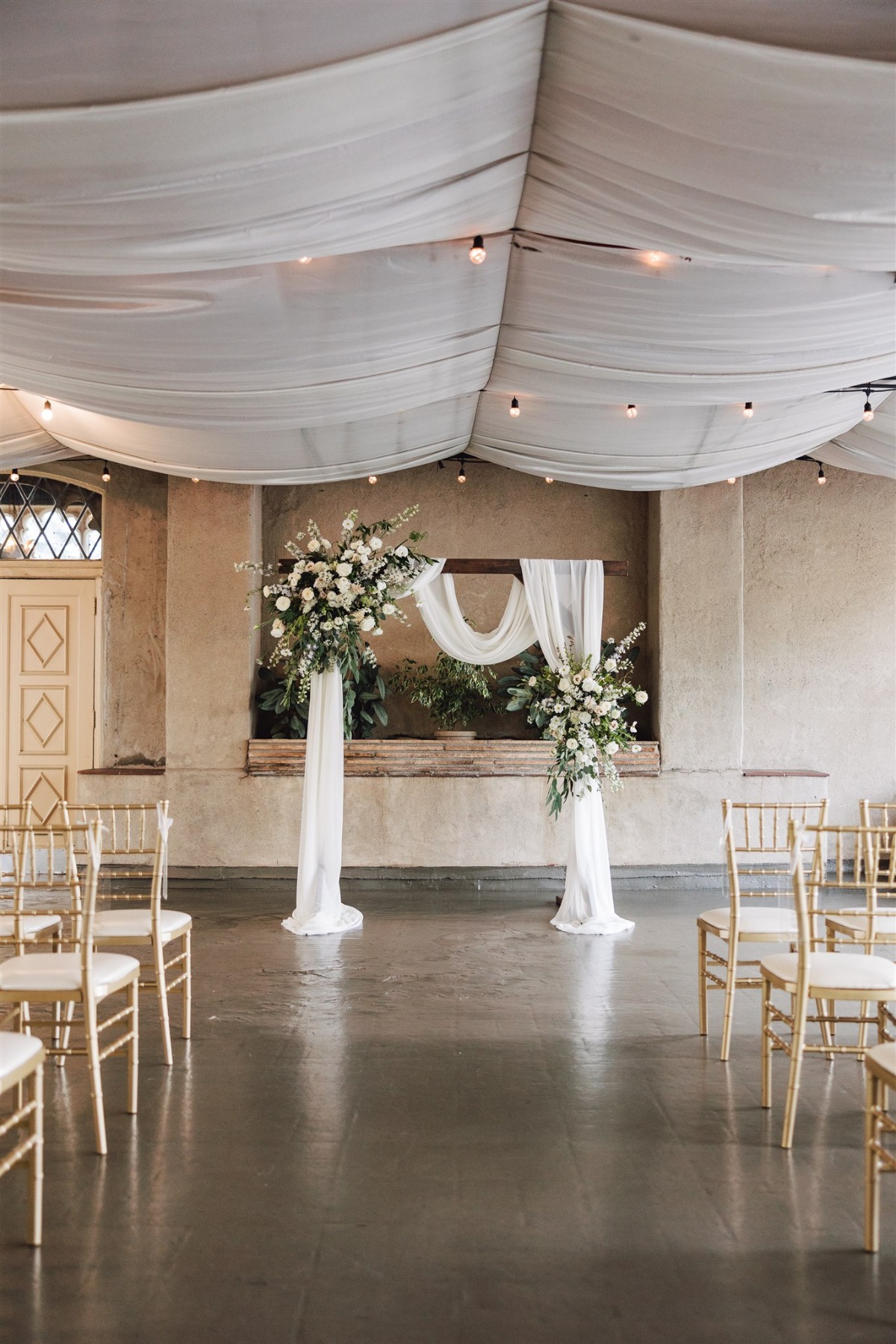 white draped wedding ceremony venue