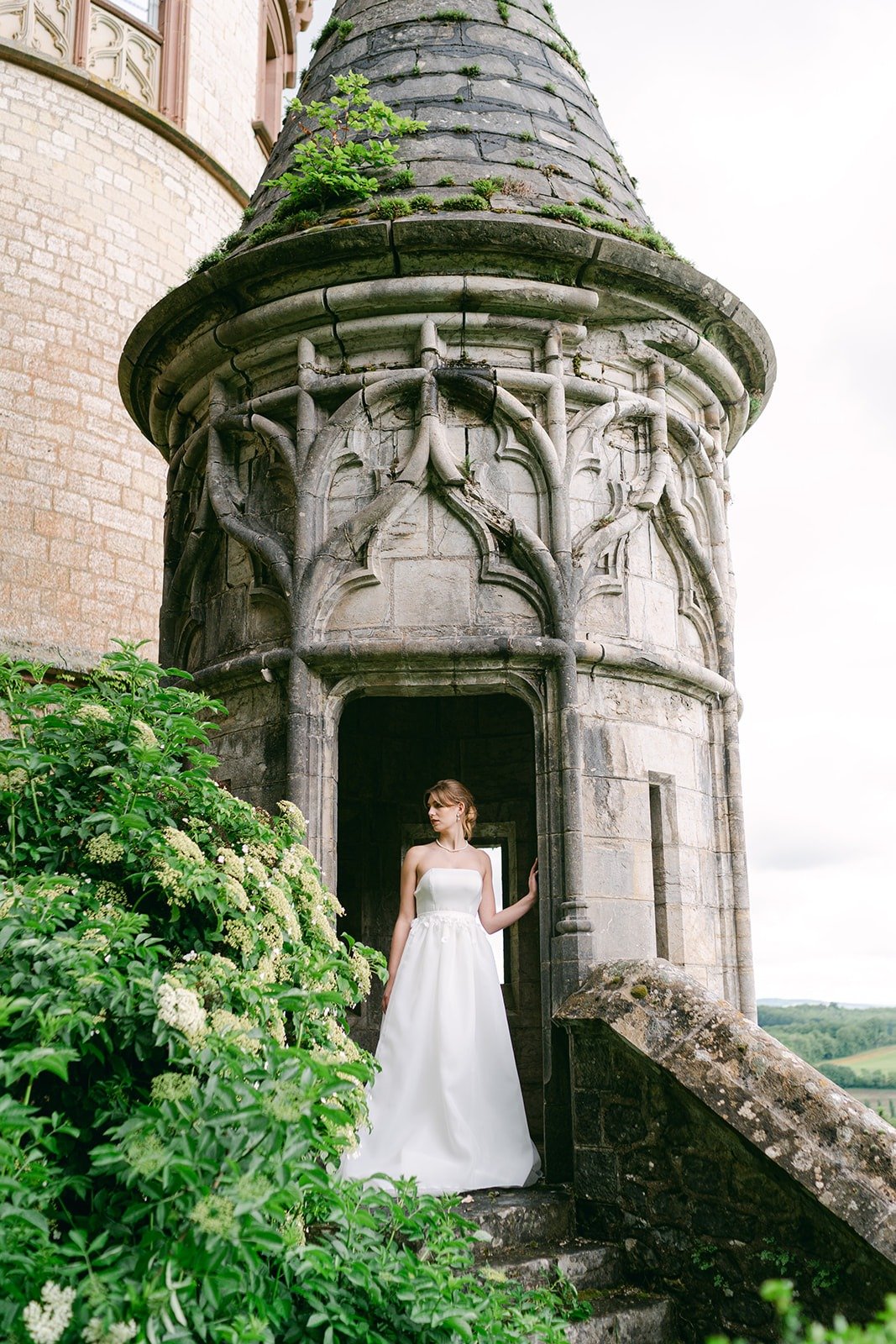 bride poses in castle turret