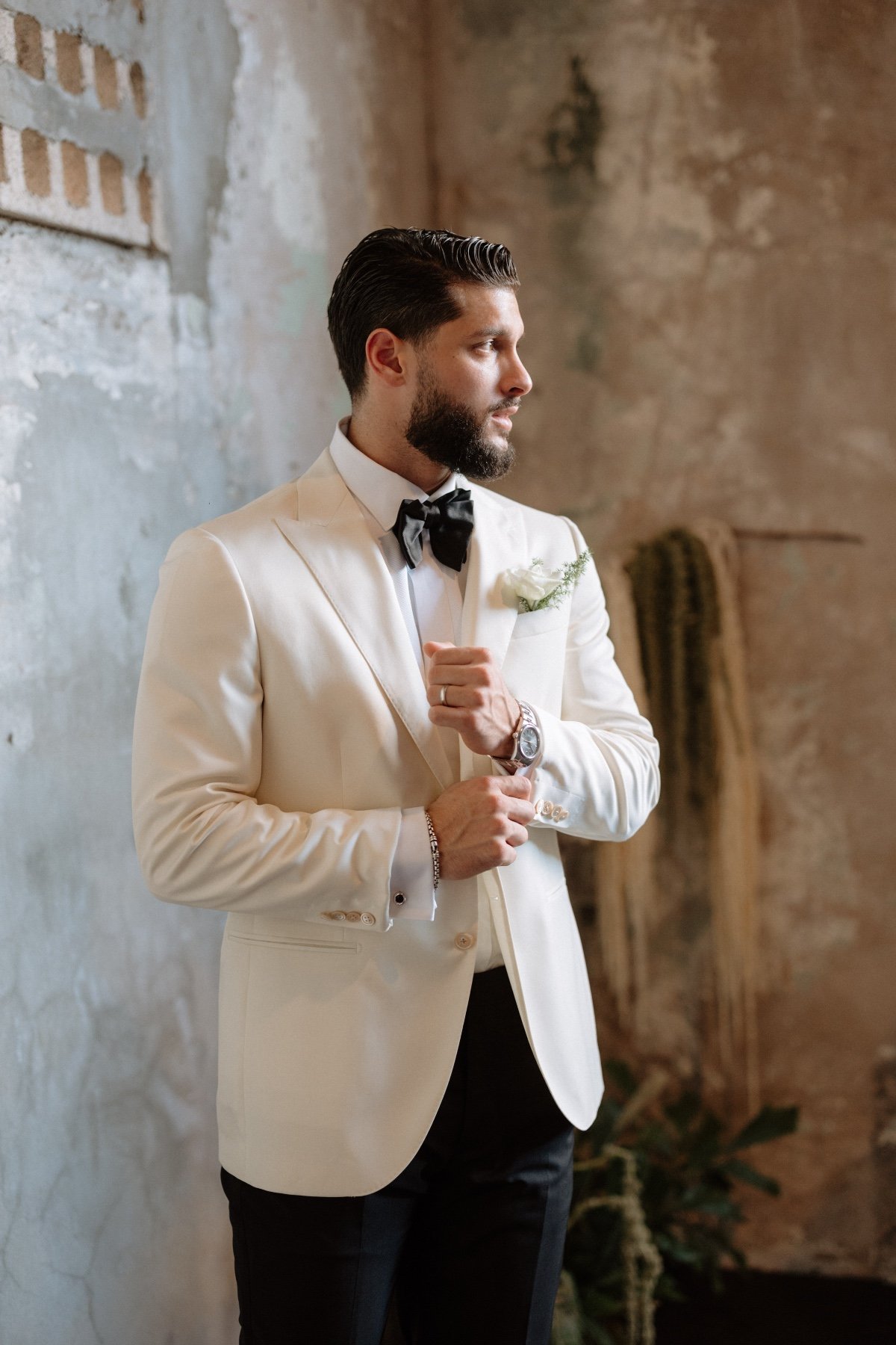 groom in ivory jacket and black tie