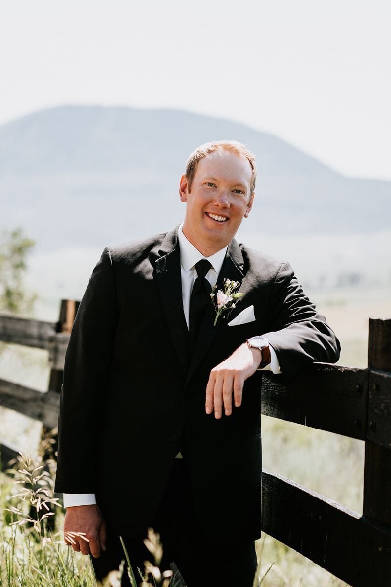 groom in black suit for outdoor wedding