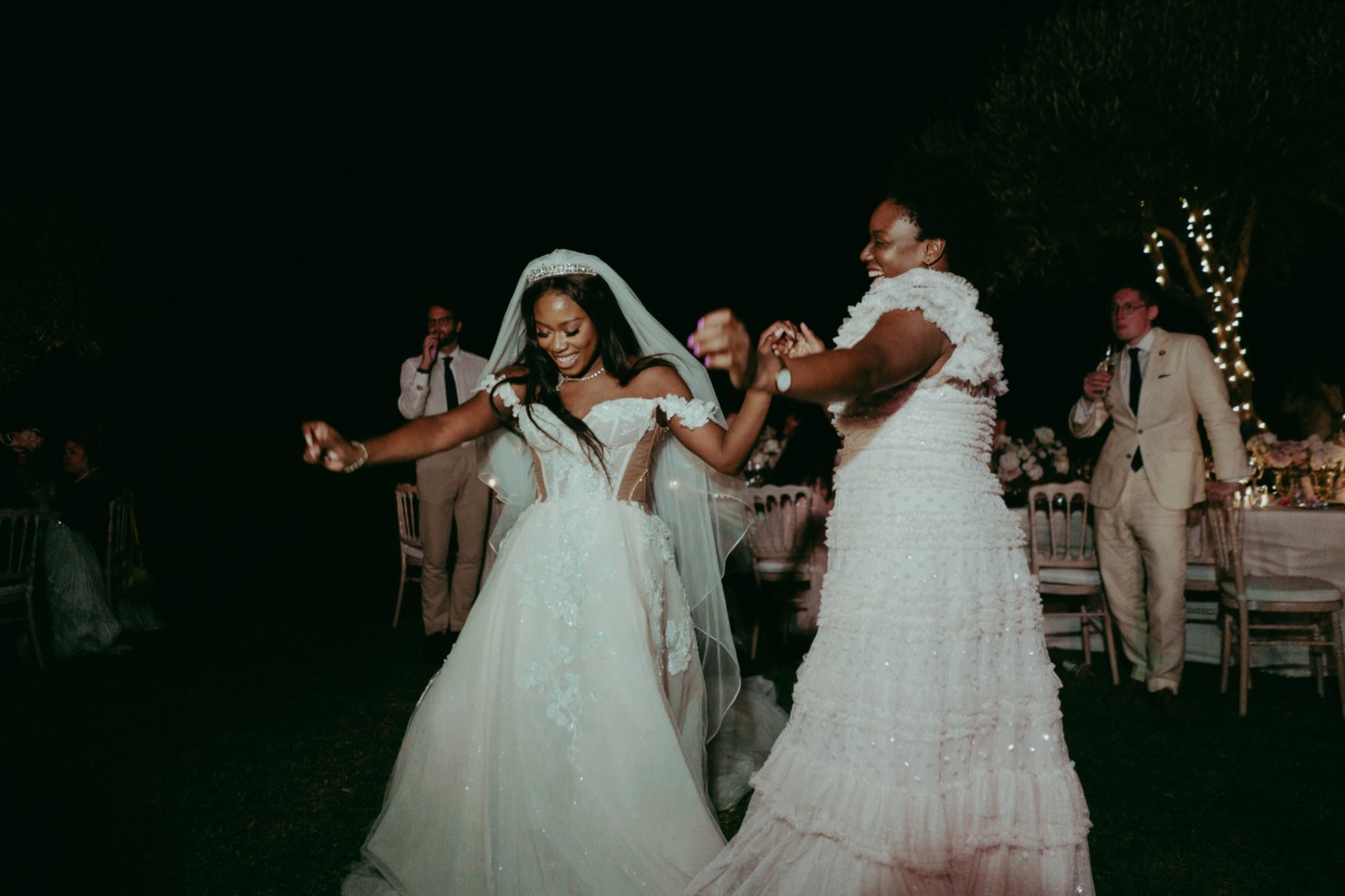 bride in galia lahav and bridesmaid dancing 