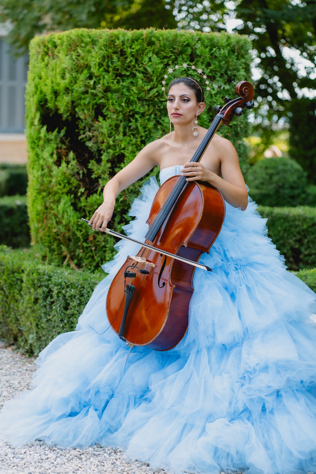 cello player in blue gown