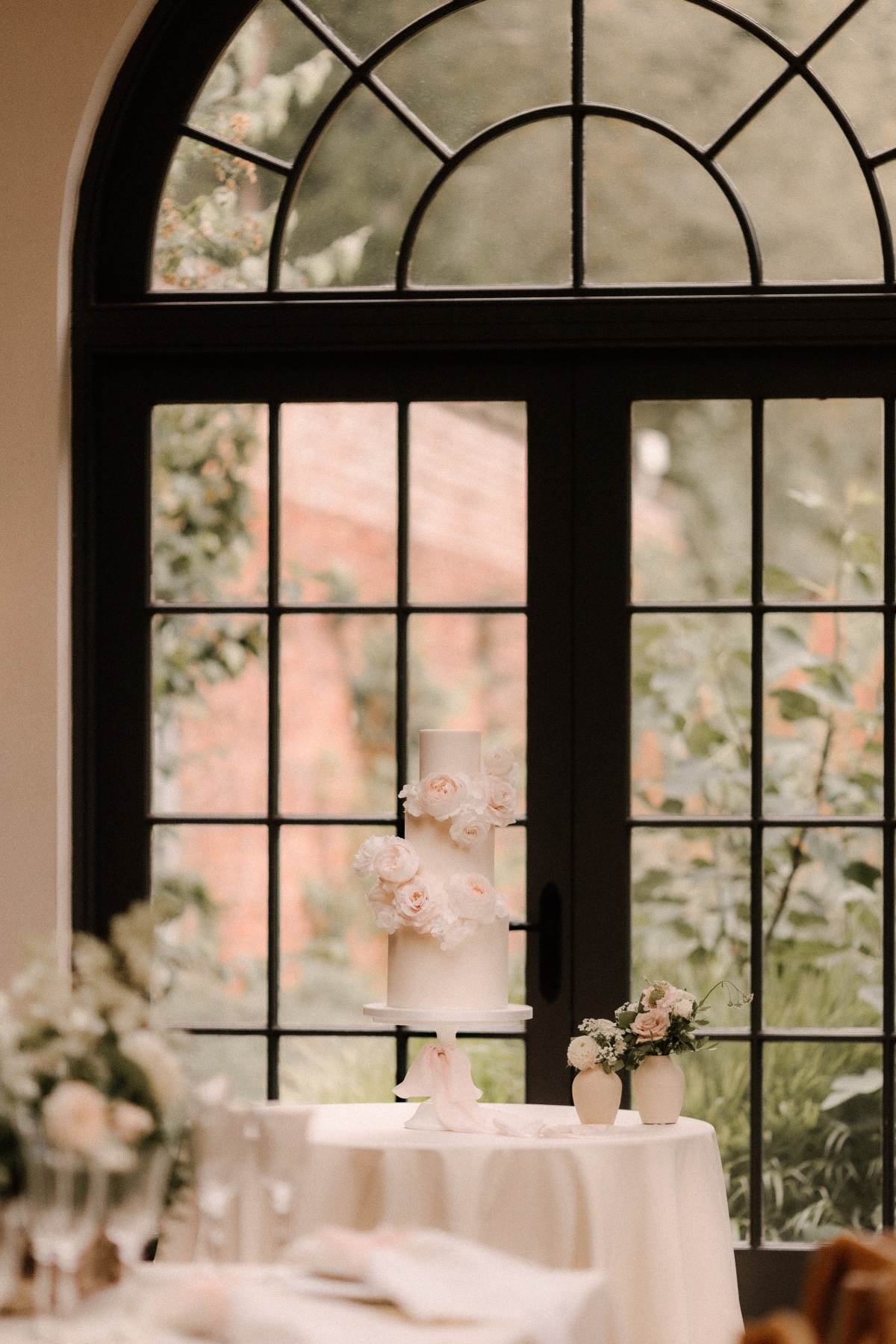 fresh blush flowers on blush wedding cake